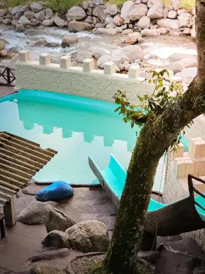 a pool of water with a blue boat in it at La Chorrera ecohotel in Cocorná