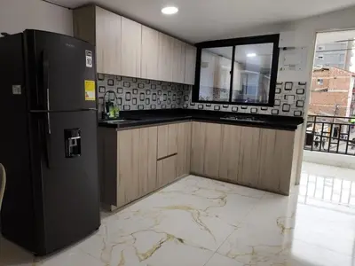 a kitchen with a black refrigerator and a window at Hermoso apartamento en la Dalia Marinilla Antq in Marinilla