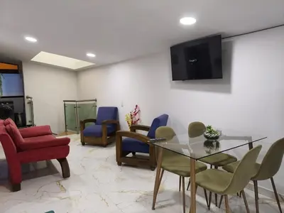 a living room with a glass table and chairs at Hermoso apartamento en la Dalia Marinilla Antq in Marinilla