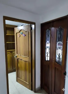 two doors in a room next to each other at Cama nueva doble con balcón cerca del parque principal in La Ceja