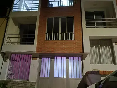a building with colorful doors in front of it at Hostal Villa Café in Manizales