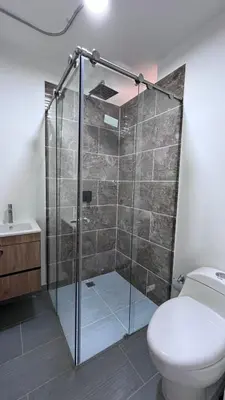 a bathroom with a glass shower with a toilet at Loft Medellin a Dos Calles del Estadio in Medellín