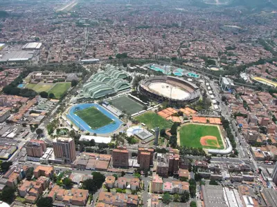 an aerial view of a city with buildings and a stadium at Loft Medellin a Dos Calles del Estadio in Medellín