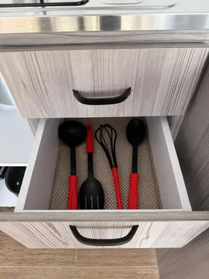 a wooden drawer with utensils in it at Descansa, comodidad y confort in Manizales