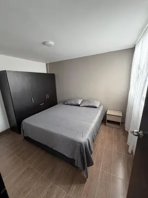a bedroom with a bed and a cabinet at Descansa, comodidad y confort in Manizales