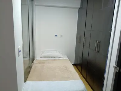 a small room with a bed and a closet at Hostal Villa Café in Manizales