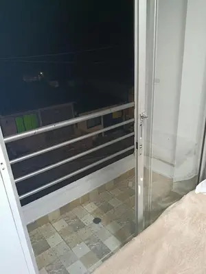 a glass door to a bedroom with a tile floor at Hostal Villa Café in Manizales