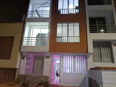 a building with pink and purple doors on it at Hostal Villa Café in Manizales