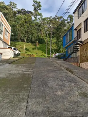 an empty street with a giraffe in the distance at Hostal Villa Café in Manizales