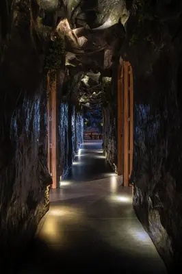 a tunnel in a cave with lights in it at The rock complete apartment in Medellín