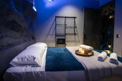 a bedroom with a bed with two towels and two candles at The rock complete apartment in Medellín