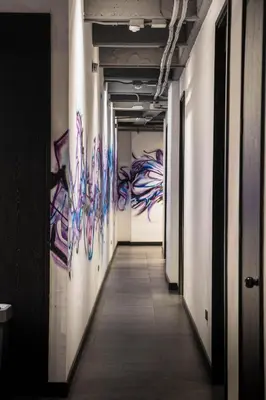 a long hallway with colorful paintings on the walls at The rock complete apartment in Medellín