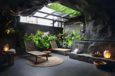 a patio with two chairs and a plant at The rock complete apartment in Medellín