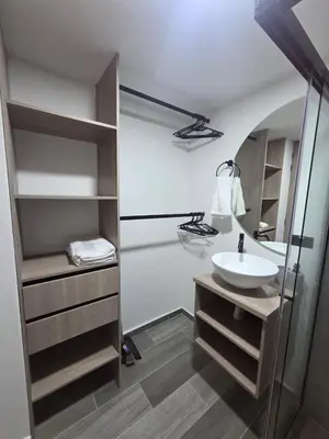 a bathroom with a sink and a walk in shower at Beautiful Laureles Studio Apartment in Medellín