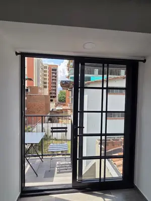 an open window with a view of a balcony at Beautiful Laureles Studio Apartment in Medellín