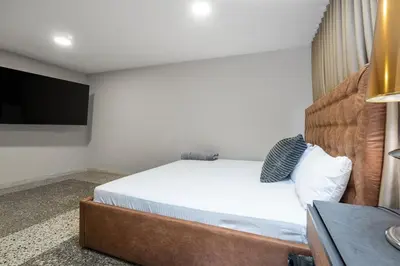a bedroom with a bed and a flat screen tv at Ph volcana in Medellín