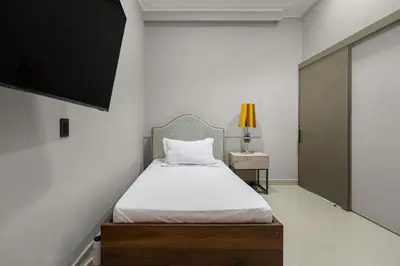 a bedroom with a bed and a tv and a table at Ph volcana in Medellín