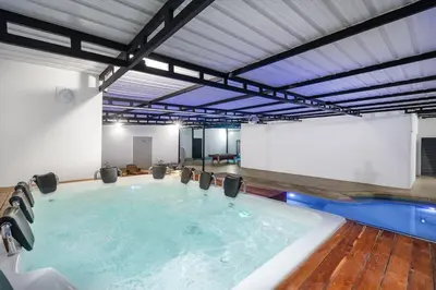a large swimming pool with a large screen in a building at Ph volcana in Medellín