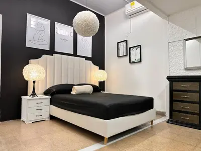 a black and white bedroom with a bed and two lamps at Group stay 21 guests, WiFi 900 Mb in Medellín