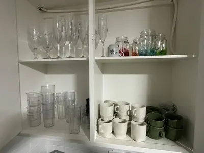 a cupboard filled with glasses and other glass items at Group stay 21 guests, WiFi 900 Mb in Medellín