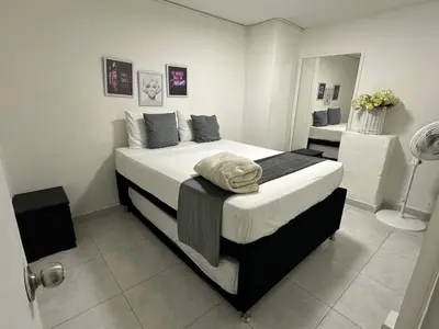 a bedroom with a large bed in a room at Group stay 21 guests, WiFi 900 Mb in Medellín