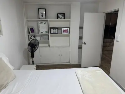a bedroom with a white bed and white shelves at Group stay 21 guests, WiFi 900 Mb in Medellín