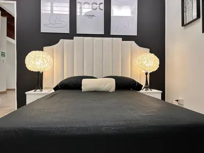 a bedroom with a large bed with two lamps at Group stay 21 guests, WiFi 900 Mb in Medellín