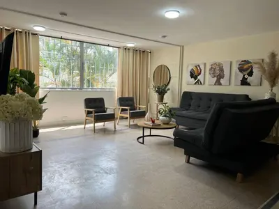 a living room with a black couch and chairs at Group stay 21 guests, WiFi 900 Mb in Medellín