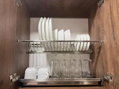 a shelf with glasses and other utensils in a kitchen at Modern and cozy apartment - Laureles Estadio in Medellín