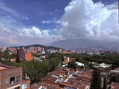 a view of a city with buildings and mountains at Modern and cozy apartment - Laureles Estadio in Medellín