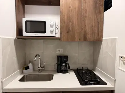 a kitchen with a sink and a microwave at Modern and cozy apartment - Laureles Estadio in Medellín