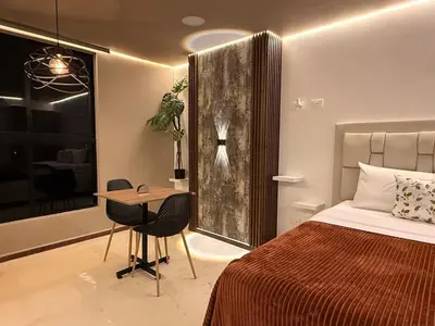 a bedroom with a bed and a table and a desk at Modern and cozy apartment - Laureles Estadio in Medellín
