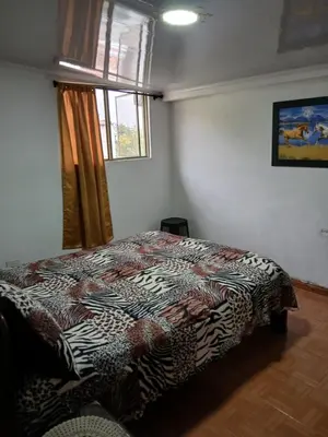 a bedroom with a bed in a room with a window at Casa grande con terraza in Manizales