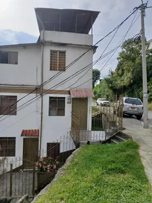 a white house with a tower on top of it at Casa grande con terraza in Manizales
