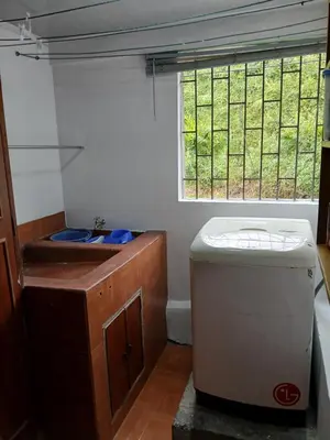 a small kitchen with a sink and a window at Casa grande con terraza in Manizales