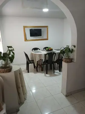 a dining room with a table and chairs at Casa grande con terraza in Manizales