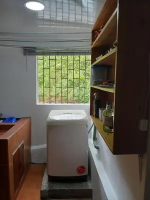 a small bathroom with a toilet and a window at Casa grande con terraza in Manizales