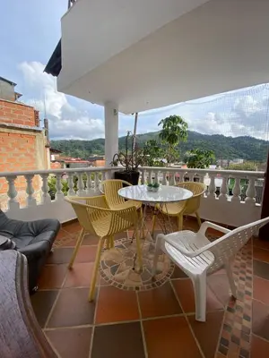 a patio with a table and chairs on a balcony at Casa Marina in San Rafael