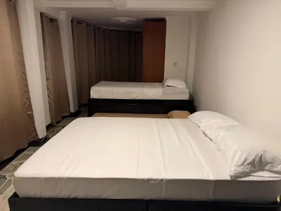 two beds in a small room with at Tu alojamiento parque caldas in Manizales