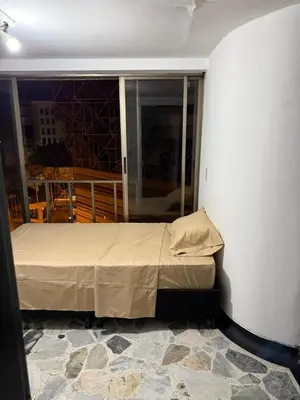 a small bed in a room with a window at Tu alojamiento parque caldas in Manizales
