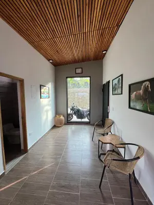 a living room with a wooden ceiling and chairs at Casa Finca en Guatapé in Guatapé