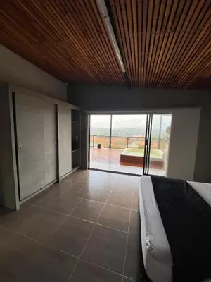 a bedroom with a bed and a large sliding glass door at Casa Finca en Guatapé in Guatapé