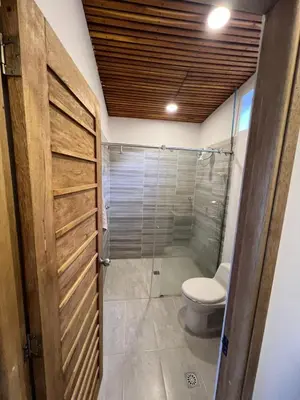 a bathroom with a toilet and a shower at Casa Finca en Guatapé in Guatapé
