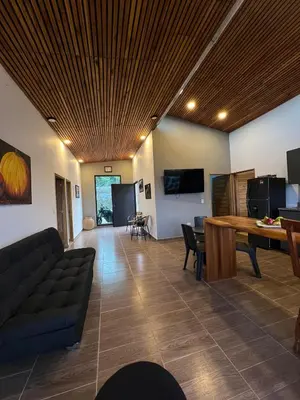 a living room with a couch and a table at Casa Finca en Guatapé in Guatapé