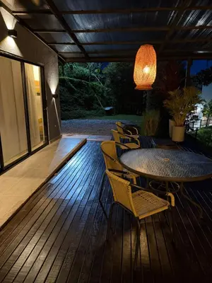 a patio with a table and chairs on a deck at Casa Finca en Guatapé in Guatapé