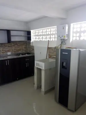 a kitchen with a refrigerator and a stove at VILLA La May in Medellín