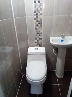 a bathroom with a toilet and a sink at VILLA La May in Medellín