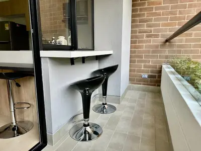 a kitchen with two black stools in a room at GRAND medellin in Medellín