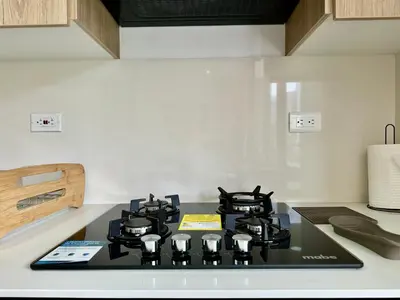 a stove top with four burners in a kitchen at GRAND medellin in Medellín
