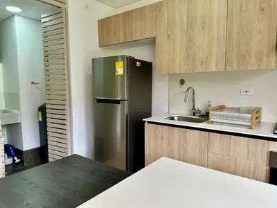 a kitchen with a refrigerator and a sink at GRAND medellin in Medellín